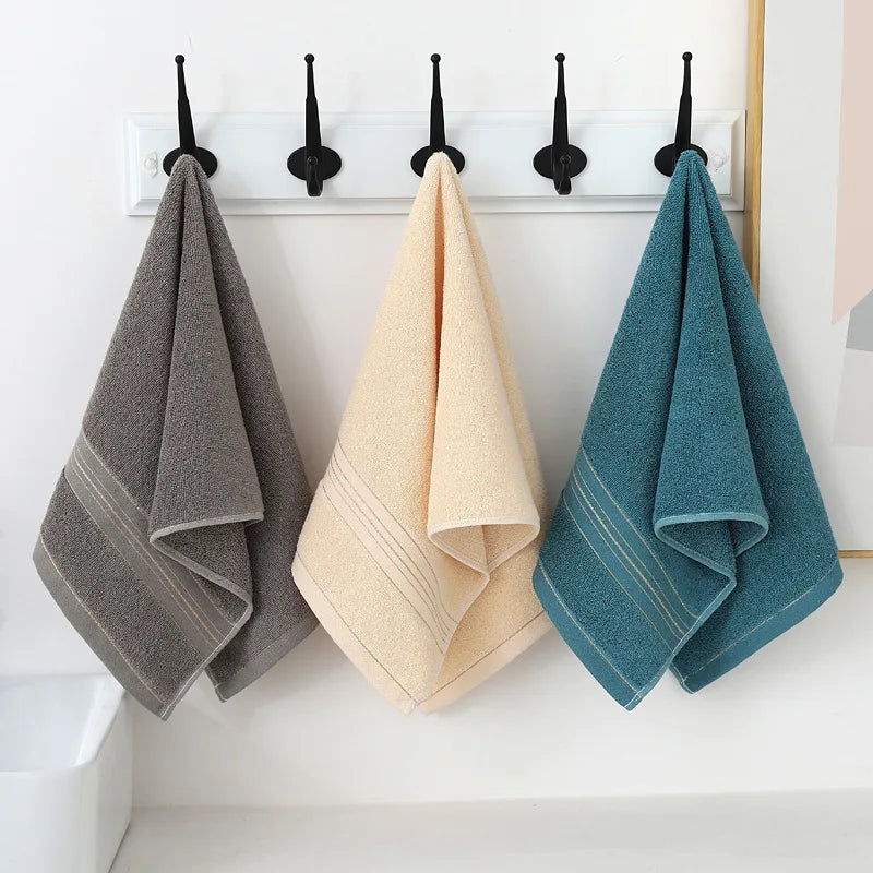 Soft cotton hand towels hanging on hooks for bathroom or camp use