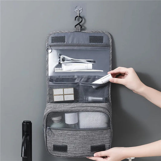 Hanging travel toiletry bag with multiple compartments for organized storage
