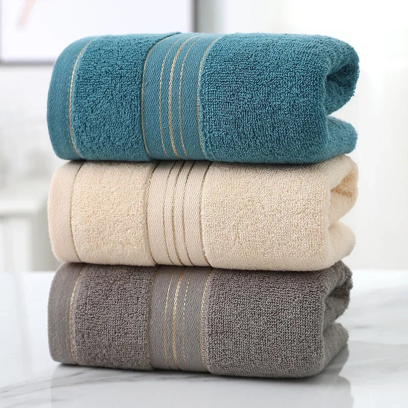 Absorbent cotton hand towels stacked in neutral colors for home and camp use